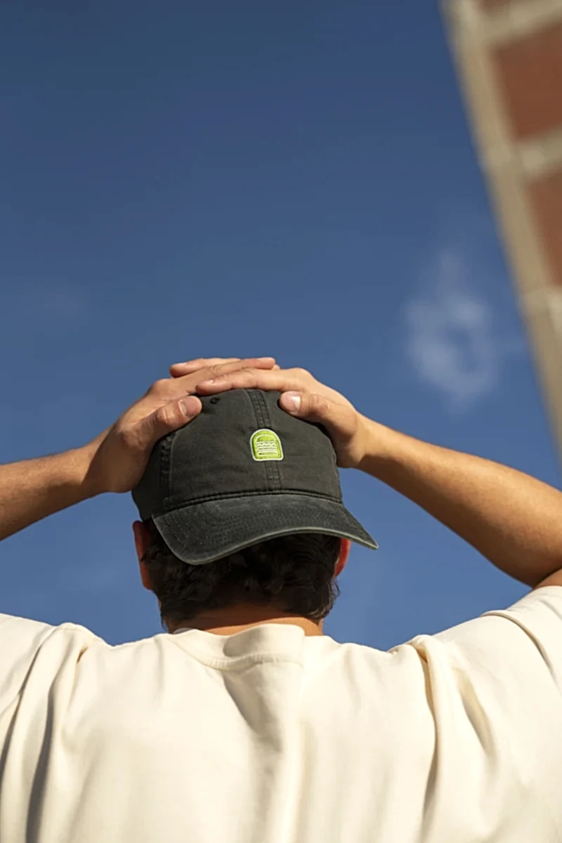 Person outside wearing Shake Shack dad hat backwards