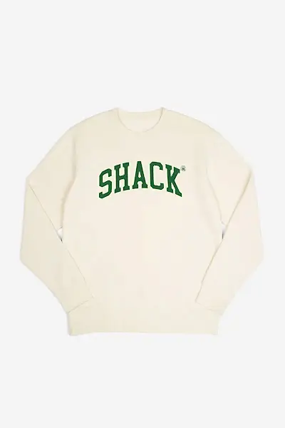 Cream-colored sweatshirt with the word "Shack" displayed across the chest
